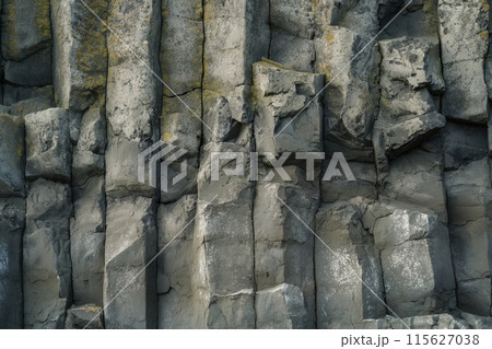 Ancient and rugged basalt column cliffs featuring hexagonal geological formations and textured volcanic rock, creating a natural pattern in the outdoor landscape Ancient and rugged basalt column cliffs featuring hexagonal geological formations and textured volcanic rock, creating a natural pattern in the outdoor landscape 115627038