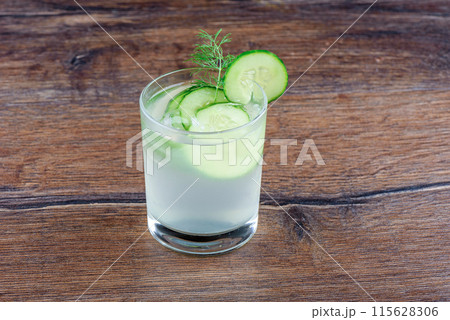 Cucumber refreshing drink glass with cucumber circles and decorated with dill. 115628306