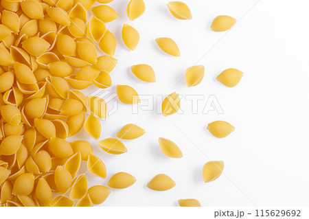 Pasta products in the form of a shell, texture, on a white background Pasta products in the form of a shell, texture, on a white background 115629692