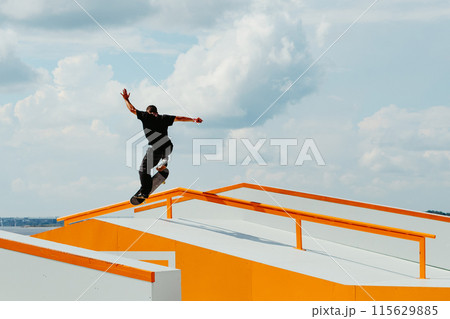 Latino man doing Manual Grind trick on skateboard 115629885