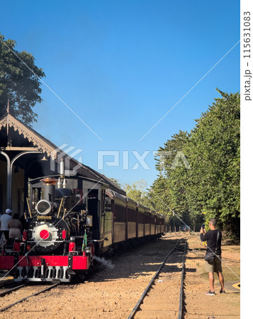 Man Capturing the Essence of Vintage Train Journey 115631083