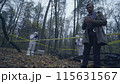 Forensic experts collecting evidence, police investigator writing down case details 115631567