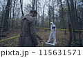 Professional investigators examining a crime scene outdoors, collecting evidence 115631571