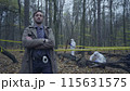 Serious police officer with arms crossed on his chest, ready to investigate a criminal case 115631575