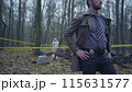 Attentive forensic experts collecting evidence at a murder scene, crime investigation 115631577