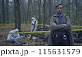 Police detective visiting a crime scene, arms crossed on his chest, waiting for a forensic report 115631579