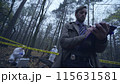 Police officer writing a report on a crime scene examination, evidence collection 115631581