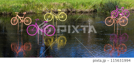 Abstract sport installation of colorful bicycles in the water 115631994
