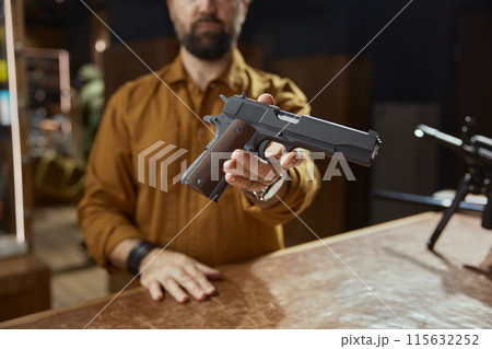 Modern automatic handgun selling at stocks of weapons 115632252
