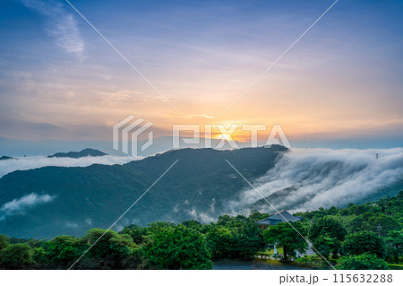 At dawn, the peaceful waterfall of clouds gradually disperses during sunrise. 115632288