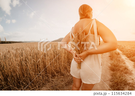 Woman wheat field. Agronomist, Woman farmer check golden ripe barley spikes in cultivated field. Closeup of female hand on plantation in agricultural crop management concept. Slow motion 115634284