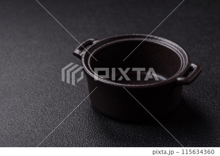 Beautiful empty white ceramic gravy boat on a concrete background Beautiful empty white ceramic gravy boat on a concrete background 115634360