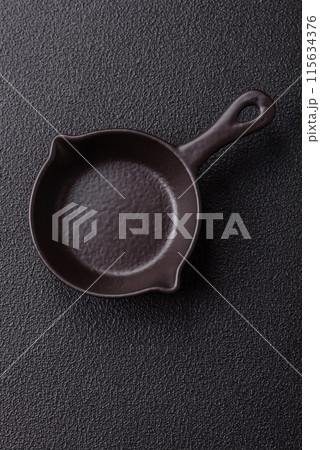 Beautiful empty white ceramic gravy boat on a concrete background 115634376