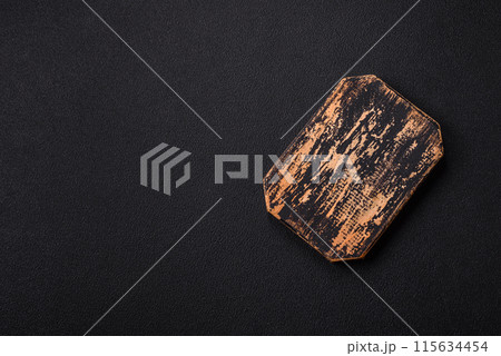 Empty wooden cutting board on dark textured concrete background 115634454