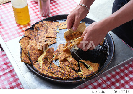 Socca, just coming out of the oven, in Nice, the French Riviera. a type of thin, Socca is a specialty of southeastern French cuisine. a pancake made from chickpea flour. Socca, just coming out of the oven, in Nice, the French Riviera. a type of thin, Socca is a specialty of southeastern French cuisine. a pancake made from chickpea flour. 115634738