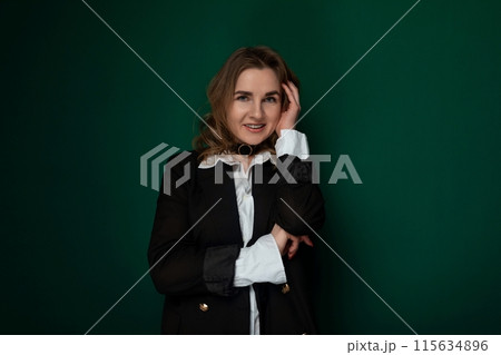 Woman in a Black Jacket Posing for Picture Woman in a Black Jacket Posing for Picture 115634896