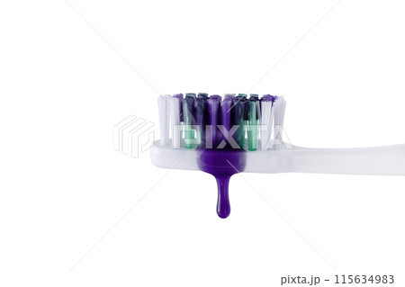Swatch of whitening purple toothpaste on a toothbrush isolated on white background. Texture of purple tooth gel for whitening teeth. 115634983
