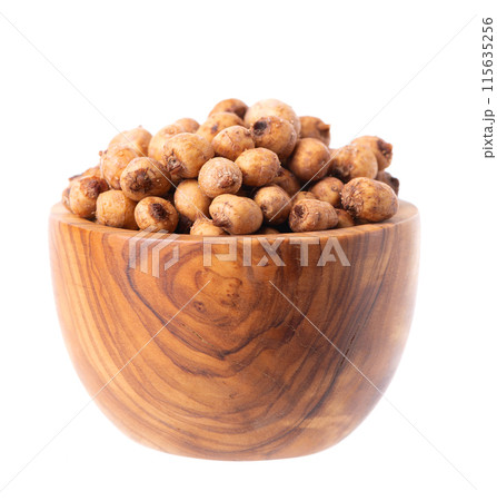 Tiger nuts in wooden bowl, isolated on white background. Pile of chufa nuts, earth almond or chufa sedge. Cyperus esculentus. Tiger nuts in wooden bowl, isolated on white background. Pile of chufa nuts, earth almond or chufa sedge. Cyperus esculentus. 115635256