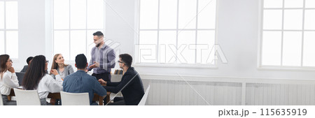 Business meeting of young team. Colleagues discussing successful contract in office, panorama with copy space Business meeting of young team. Colleagues discussing successful contract in office, panorama with copy space 115635919