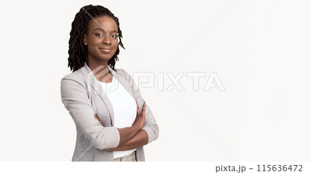 Self-confident African American corporate woman dressed in a grey blazer, isolated on a white background, with plenty of room for text. 115636472