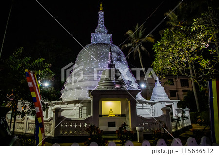 traditional Sri Lankan white temple stupas in evening. 115636512