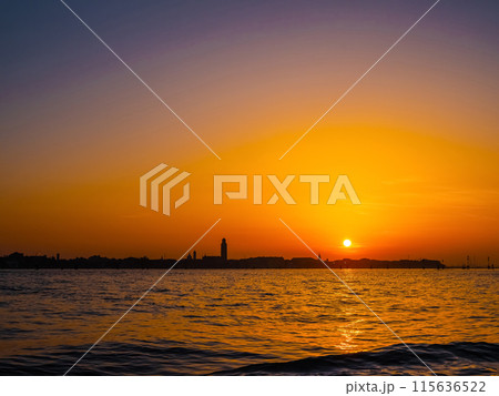 silhouettes of Venice at sunset , view from water 115636522