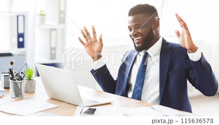 Excited african american businessman expressing joy and happiness in office, got new clients, looking at laptop, free space Excited african american businessman expressing joy and happiness in office, got new clients, looking at laptop, free space 115636578