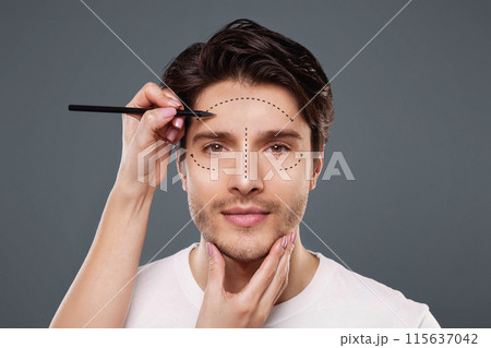 Plastic surgery concept. Surgeon drawing marks on male face on gray background, panorama 115637042