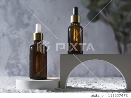 Glass dropper bottles with natural cosmetic on podium. Product presentation mock up. Beauty and body care product concept. Nature oil skin concept. Concrete geometric scene. 115637478