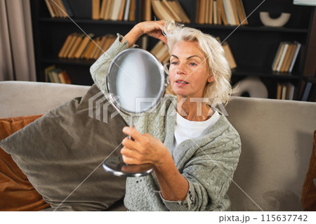 Love yourself. Beautiful old mature woman enjoying mirror reflection. Senior adult older lady looking at mirror confident happy on sofa at home. Woman doing daily morning beauty routine. Self love Love yourself. Beautiful old mature woman enjoying mirror reflection. Senior adult older lady looking at mirror confident happy on sofa at home. Woman doing daily morning beauty routine. Self love 115637742