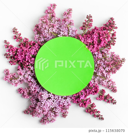 Branches of blooming purple lilac on gray background with around green round shape made of paper for text. Copy space, flat lay, mockup for special offers as advertising or other ideas 115638070