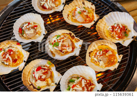 grilled scallops with cheese on the grill 115639361