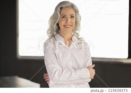 Successful Entrepreneurship. Portrait Of Middle Aged Businesswoman With Gray Hair Smiling To Camera Standing In Modern Office Interior. Business Career, Employment Concept 115639373