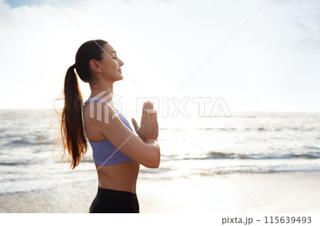 Calm glad young caucasian woman enjoy morning workout alone, silence, calm and breathing exercises, practicing yoga on sea beach. Meditation, sports, lifestyle and body care outdoor Calm glad young caucasian woman enjoy morning workout alone, silence, calm and breathing exercises, practicing yoga on sea beach. Meditation, sports, lifestyle and body care outdoor 115639493
