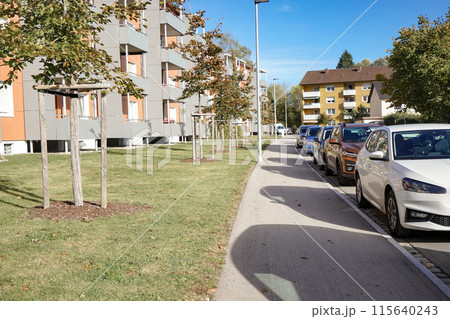 Cars on the road parked near multi-storey buildings in the city. 115640243