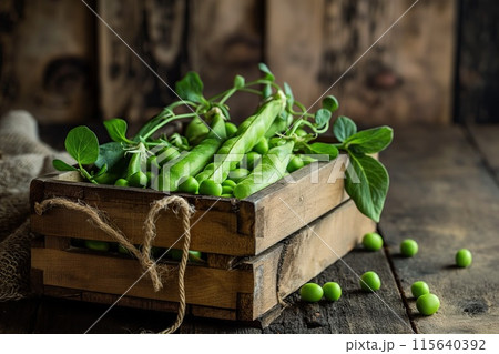 Fresh green peas in a wooden box, rustic style 115640392