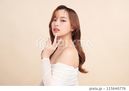 Beautiful young asian woman with clean fresh skin on beige background, Face care, Facial treatment, Cosmetology, beauty and spa, Asian women portrait. 115640776