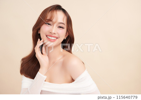 Beautiful young asian woman with clean fresh skin on beige background, Face care, Facial treatment, Cosmetology, beauty and spa, Asian women portrait. 115640779