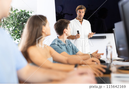 Positive teacher leading group of youth attending computer class 115642169