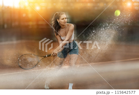 Stylized shot of young female tennis player swinging racket to hit ball Stylized shot of young female tennis player swinging racket to hit ball 115642577