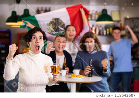 Joyful fans of the Mexican team celebrating the victory in night bar 115642607