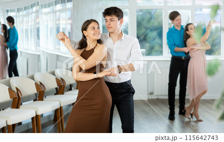 During rehearsal, guy and girl participants of dance workshop perform social pair dance During rehearsal, guy and girl participants of dance workshop perform social pair dance 115642743