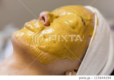 A girl at a cosmetologist does cosmetic procedures. Alginate mask A girl at a cosmetologist does cosmetic procedures. Alginate mask 115644294