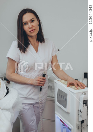 Cosmetologist esthetician performs skin treatment and rejuvenation Cosmetologist esthetician performs skin treatment and rejuvenation 115644342