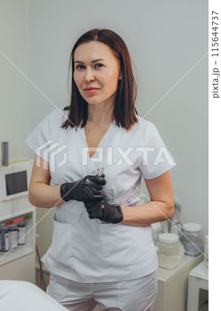 Cosmetologist esthetician performs skin treatment and rejuvenation 115644737