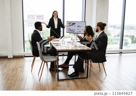 Diverse business team applauding during presentation with charts Diverse business team applauding during presentation with charts 115645627