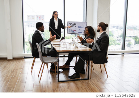 Caucasian business woman giving a presentation to diverse colleagues Caucasian business woman giving a presentation to diverse colleagues 115645628
