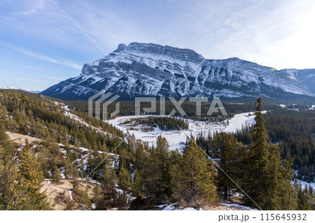 Banff National Park beautiful landscape. Panorama view Mount Rundle valley forest and frozen Bow River in winter. Hoodoos Viewpoint, Canadian Rockies. 115645932