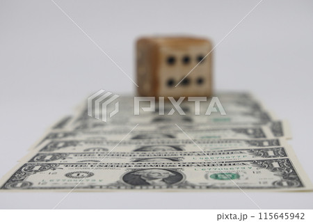 Road from dollar bills and homemade dice isolated on white background, unpredictability of financial 115645942