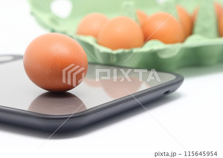 Eggs on a flat kitchen scale and in a carton, calorie counting, diet, practical nutrition. 115645954